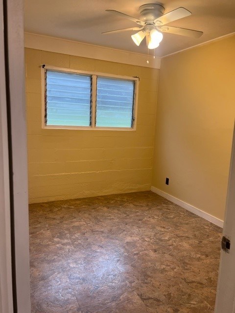 A room with a ceiling fan and a window with blinds.
